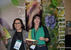 Happy faces in the booth of Gourmet Trading. Patty Ruiz and Kristen Francisco proudly show green, white and purple asparagus.