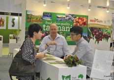 Phil Pyke, the business development manager of Fruit Growers Tasmania is informing an international audience at his stand.