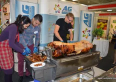 A pig on a spit sending a delicious aroma around the hall.