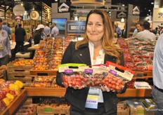 Helen Aquino from Village Farms holds the Lipsmack, Cabernet and Cherry No 9 tomato.