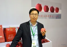 He Peng at the booth of Long Yuanhong Fruits Selling. Long Yuanhong is a large apple producer, importer and exporter