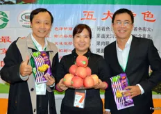 Liu Linghua from Qing Yang County is representing the County's new apple crop. Left and right are Tran Thu Nguyen and Le Quang Nguon from the Mekong Fruit Company from Vietnam. They traveled to Shanghai to show their dried tropical fruits and fruit chips