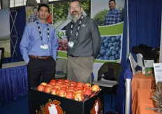 Aaron Deherrera and Ron Conrad with Rainier Fruit. In front, Lady Alice apples that will be shipped as of January.