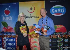 Katherine Grove and Tim Welsh with Columbia Marketing International showing Ambrosia and Kiku pouch bags of apples.