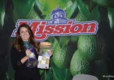 LeighAnne Thomsen with Mission Produce, Inc. shows avocados as well as a brochure with information about a recent relaunch of the company's website.