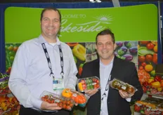 Mario Testani and Troy Gage showing different products of Lakeside Produce. Mario shows cherry tomatoes and heirloom tomatoes. Troy shows a trio of mini peppers, cucumbers and tomatoes as well as brown tomatoes.
