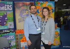 Michael and Erin Reimer with Brandt Farms in front of the Simple Simmons persimmon display.