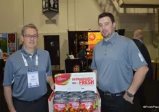 Mike Reed and Len Krahn with Oppy, showing the jar packaging of the company's Outrageously Fresh product line.