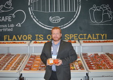 Jeremy Stockwell with Double Diamond Farms shows a 2- pack of heirloom tomatoes.