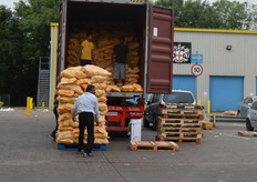 An unusual sight at the market. A container of coconuts being unloaded.