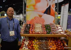 Brad Maaske with Wholesale Produce Supply. The company had many different produce items on display, including many tomato varieties.