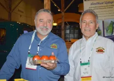 Jose Marrero with Farm Stand Fresh Foods and Jeff Trickett with Bejo Seeds, showing organic Tasti-Lee tomatoes.