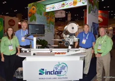 Maria Montalvo, Mark Reed, Chris Faxon and Willard Shay from Sinclair surrounding the POD (Print on Demand) machine. The machine recognizes the fruit or vegetable variety. It prints the PLU and variety/brand on the label.