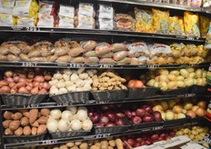 Packaged potatoes as well as bulk. A selection of onions, garlic, and ginger.