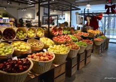 The food market is entered through the produce department. Many produce items are merchandised in baskets.