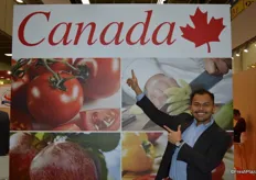Richie Santosdiaz proudly showing the Canada Pavilion sign.