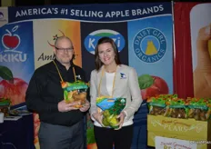 Cole Jessup and Katherine Grove with CMI Orchards. Cole holds the number 1 selling 2lb. pear bag and Katherine shows a pouch bag with Daisy Girl apples.