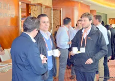 Networking during the break. In the middle is Gabriel Figueroa of Global Shang International.