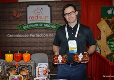 Kyle Moynahan with RedSun Farms shows cherry tomatoes on the vine.
