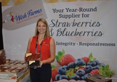 Amber Maloney with Wish Farms proudly shows strawberries and blackberries.