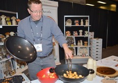 Justin Reyes with Gourmet Mushrooms Inc. is preparing mushroom samples for show attendees.
