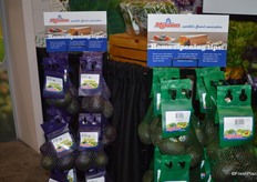 Mesh bags with avocados from Mission Produce. The purple bags contain organic avocados while conventional product is packaged in green bags.