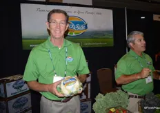 Bob Montgomery with BeachSide Produce shows organic cauliflower while his colleague Gilbert Hinojosa talks to visitors at the booth.