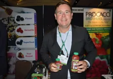 Tom Lyons with GoodFarms shows cold-pressed organic strawberry juice.