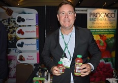 Tom Lyons with GoodFarms shows cold-pressed organic strawberry juice.