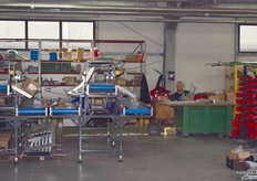 Technicians hard at work, constructing machines for customers.