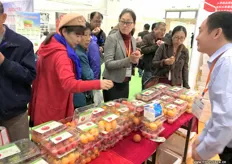 Visitors are eagerly trying some tomatoes at the stand of Volpusi, tomato grower and breeder from Shandong Province in China.