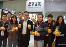 The Agricultural Revolution from Beijing is bringing new brands onto the market. This is the company's orange variety and brand. Chinese domestic brands are becoming more common and developing rapidly. Hu Hai Qin, in the middle in a white shirt, is the company's director and marketing strategist.
