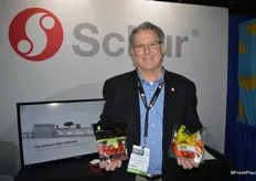 Tom Muller with Schur Systems sells both the equipment and packaging of the products that Tom is showing in the picture.