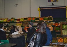 The store of John Vena, Inc. John talks to the group about the produce selection.