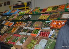 Wide selection of produce at John Vena, Inc. including many tropical and exotic options like star fruit, passion fruit, papaya, pomegranate and coconuts. The back row contains a number of hot pepper and bell pepper options.