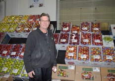 Bobby Mueller with Nardella, Inc. proudly stands in front of the apple display at Nardella's store.