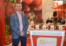 Jakub Krawczyk from Appolonia, next to a display of the different apple varieties the company produces.