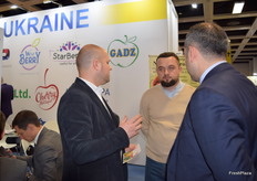 Dmitro Kroshka from UKRSADPROM Association (left), speaking to visitors at the Ukrainian stand.