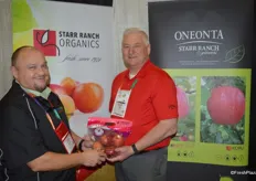 Keith Brown with Cranford's and Dan Wohlford with Oneonta Starr Ranch show a pouch bag of organic Fuji apples.