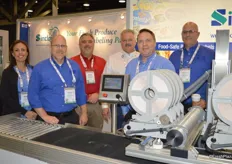 Maria Montalvo, Scott Howarth, David Ramynke, Mark Reed, Chris Faxon and Brandon Hobson with Sinclair. The company features its compact pattern tray labeler.