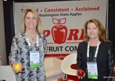 Kristina Conrad and Suzanne Wolter with Evans Fruit Company are holding a Golden Delicious and Gala apple.