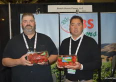 Jerry Summers and Bobby Rigor with CBS Farms showing conventional and organic strawberries respectively.