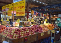 Fruit stall that offers a wide selection of apples.