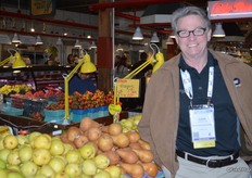 Dan Harrington with Domex Superfresh Growers looks at the pears on display.