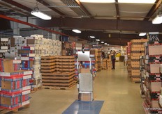 Boxes are being folded and prepared at the mezzanine level of the building.