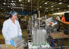 Smiling employee gets clamshells ready to be filled.