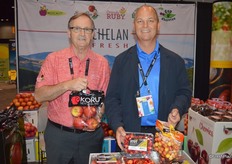 Stewart Lang and Mac Riggan with Chelan Fresh show Koru apples, as well as Orondo Ruby and Rainier cherries.