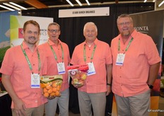 Proudly wearing peach colors during peach season. From left to right are Brent Shammo, Tom Drury, Dan Wohlford and Dan Davis with Starr Ranch Organics. Brent shows organic apricots in a pouch bag and Dan shows a pouch with organic apples.