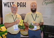 Scott Ross and Jared Bray with West Pak Avocado. Scott shows a mesh bag with smaller size avocados. The product is branded as Lil' Cados. Jared shows California-grown organic avocados.