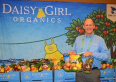 Daisy Girl, the organic brand of CMI Orchards. George Harter shows pouch bags with Daisy Girl Kiku and Ambrosia apples, as well as a bag of Daisy Girl cherries.